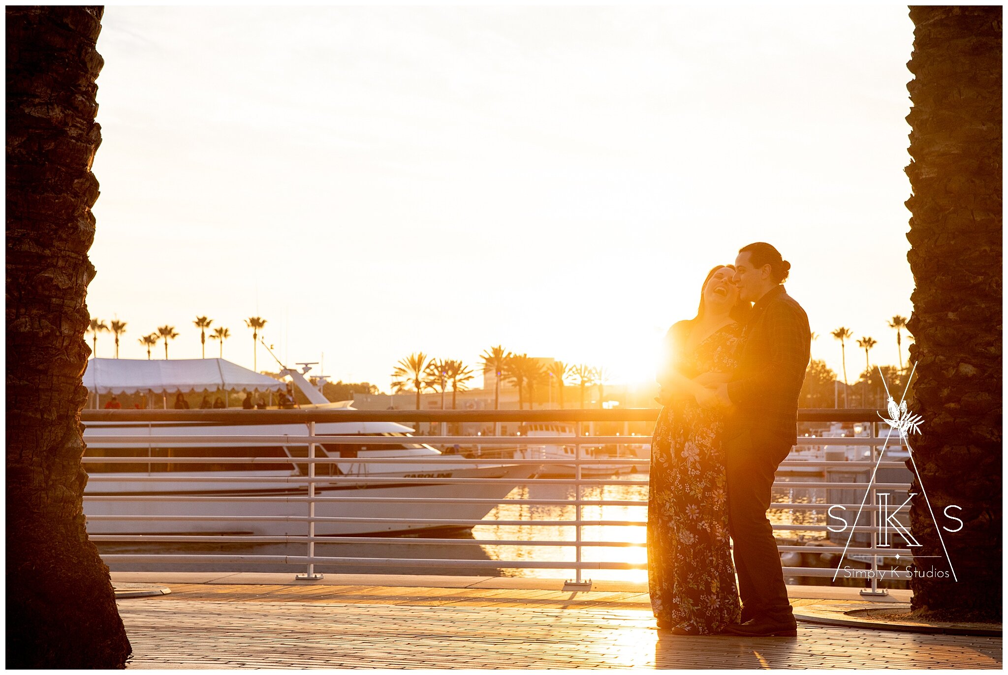  A man and woman in front of a sunset 