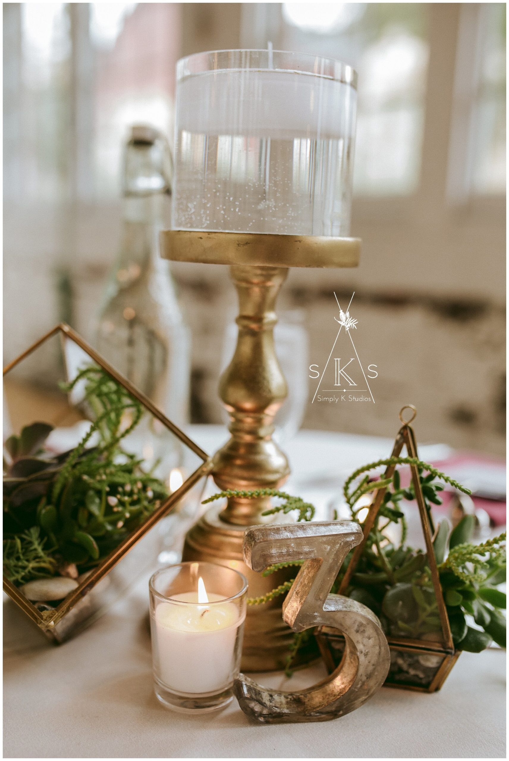 candlestick and pillar candle on a table 