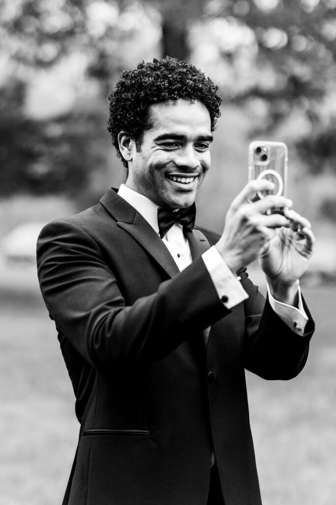 a groomsman taking a selfie