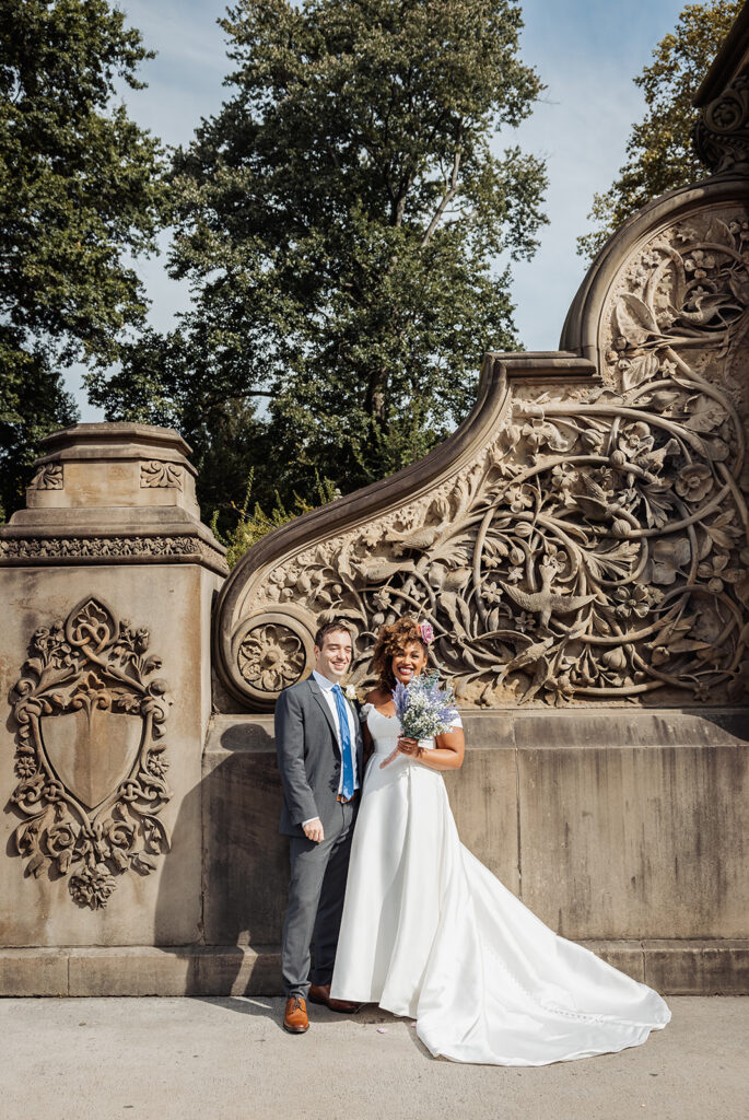 bride and groom walking around and enjoying themselves at bethesda fountain area in nyc