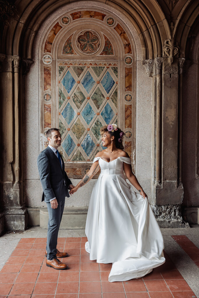 bride and groom walking around and enjoying themselves at bethesda fountain area in nyc