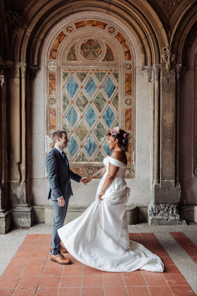 bride and groom walking around and enjoying themselves at bethesda fountain area in nyc