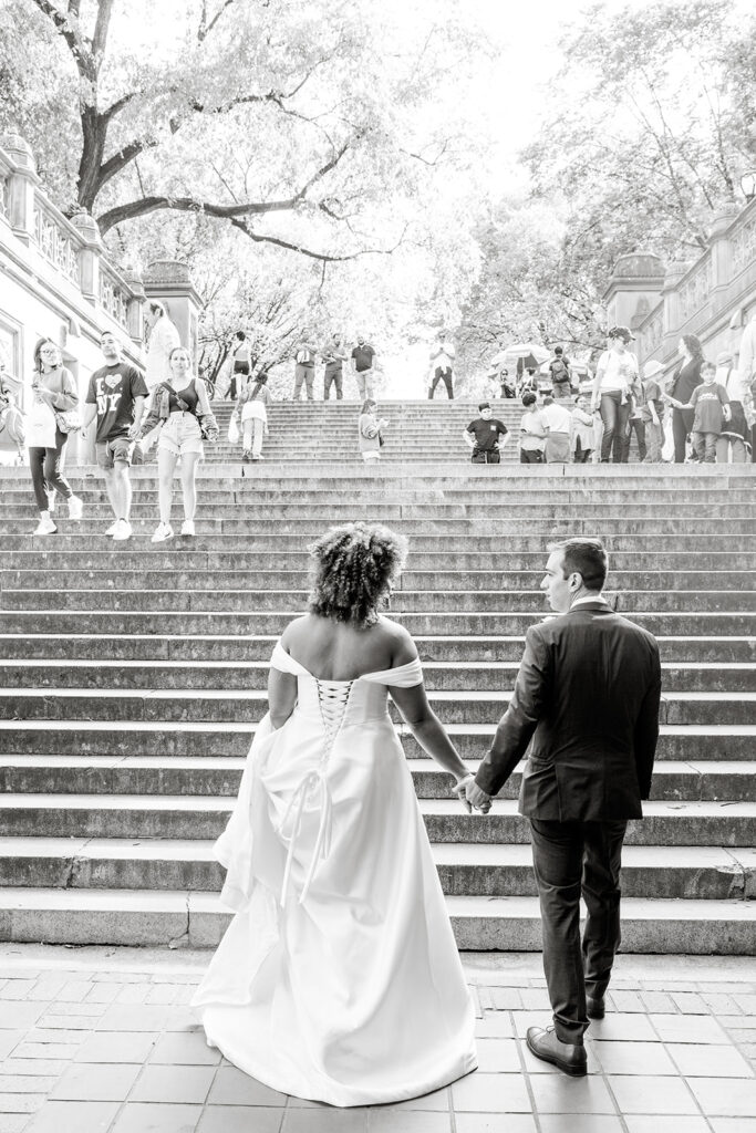 bride and groom walking around and enjoying themselves at bethesda fountain area in nyc