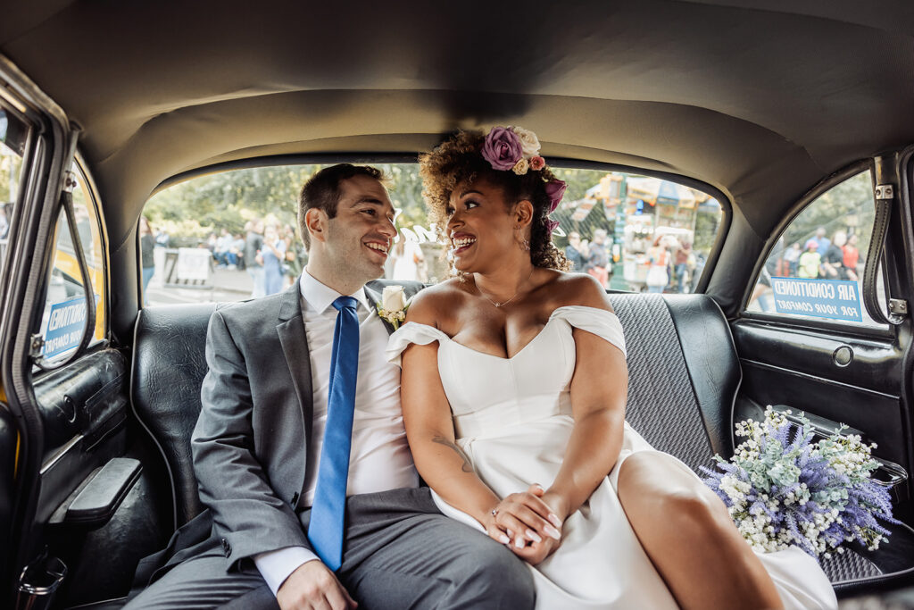 bride and groom in a cab driving around NYC