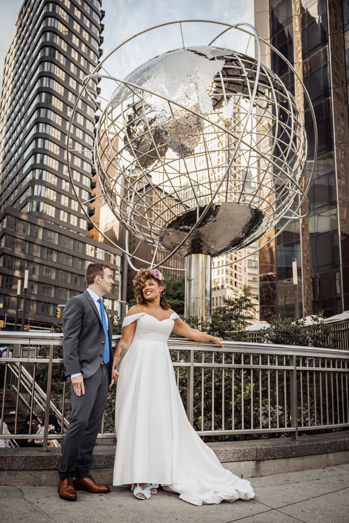 Bride and groom at the Columbus Circle with the giant globe structure