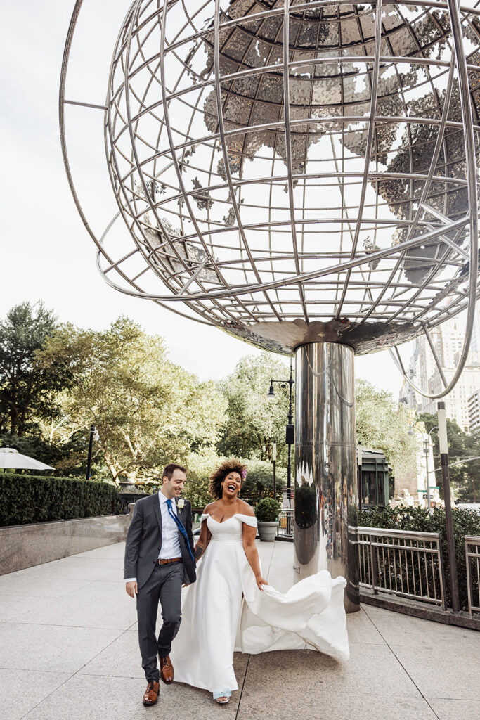 Bride and groom at the Columbus Circle with the giant globe structure