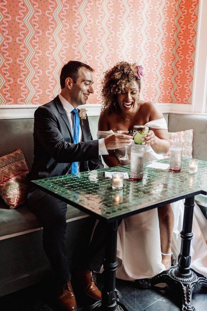 joyful bride and groom enjoying a drink during their nyc elopement at Sundry