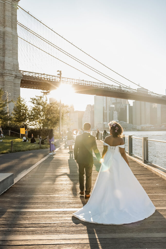 Bride and groom walking along the waterfront at Dumbo NYC