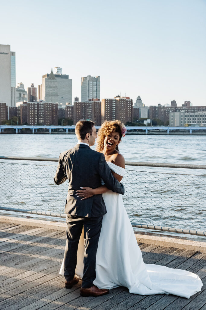 Bride and groom walking along the waterfront at Dumbo NYC