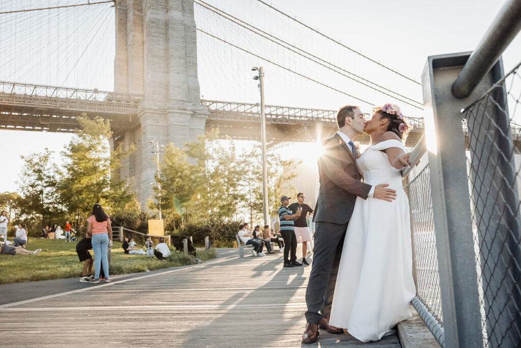 Bride and groom walking along the waterfront at Dumbo NYC