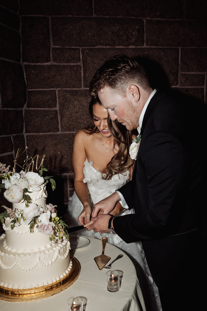 bride and groom cutting their cake