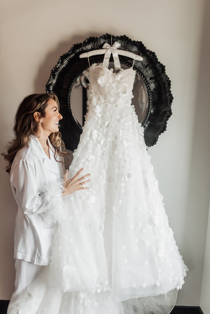 bride looking at her beautiful wedding gown