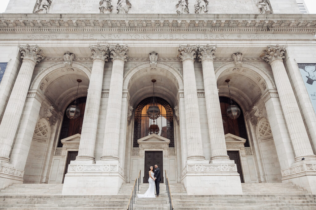 bride and groom in front of the new york public library during their nyc elopement day
