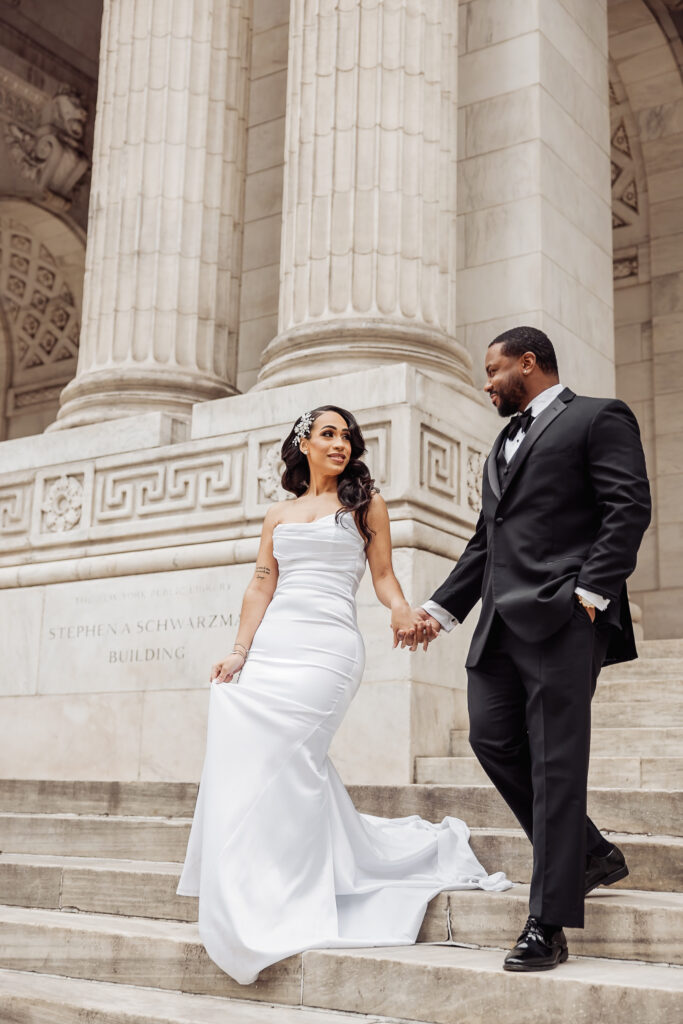 bride and groom in front of the new york public library during their nyc elopement day