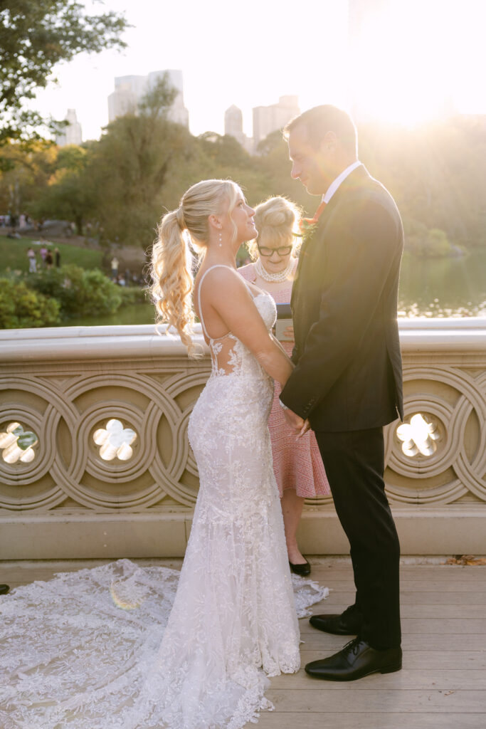 candid elopement ceremony moments on bow bridge during their nyc elopement