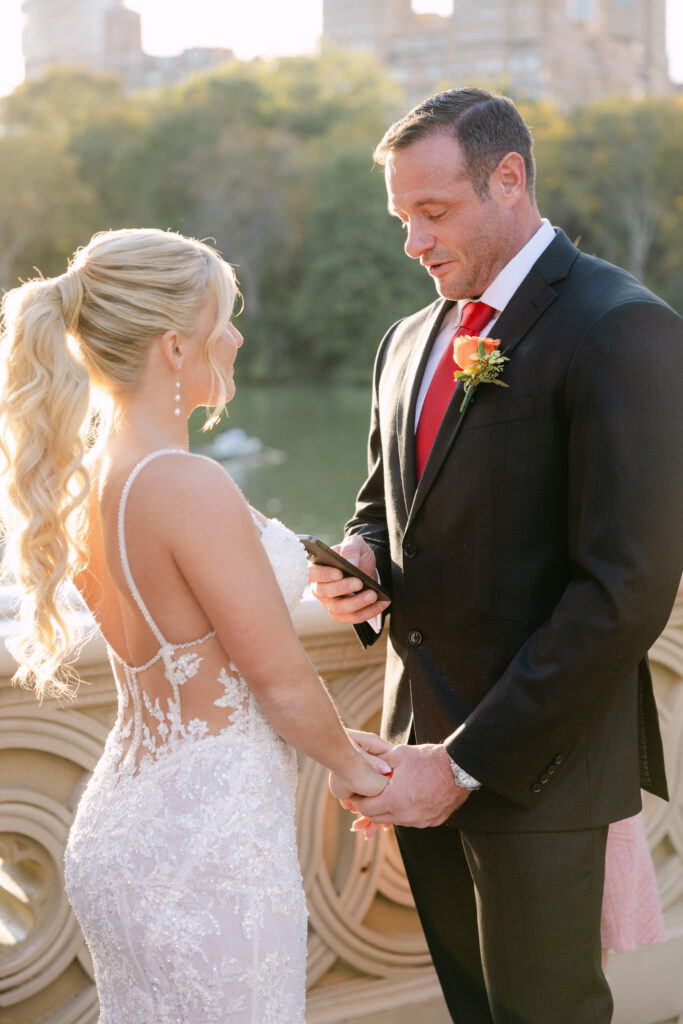 candid elopement ceremony moments on bow bridge during their nyc elopement