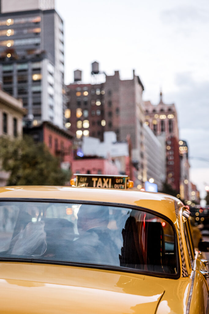 bride and groom kissing inside an iconic nyc yellow cab
